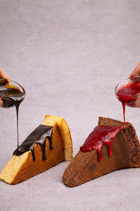 Moi Doughssier Basque cheesecake slices with chocolate and berry sauce being poured